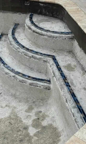 stone and tile setting of pool steps and coping